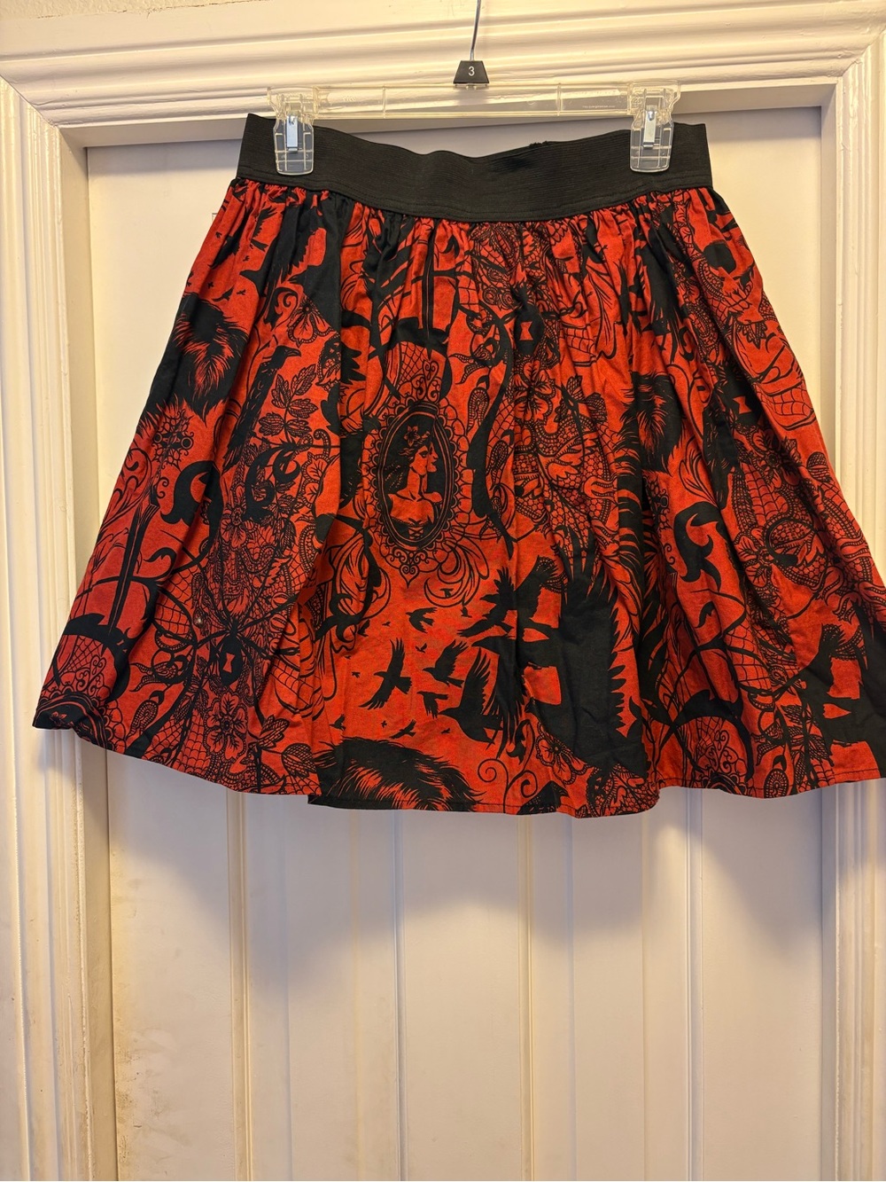 Hemet Large crows,feathers and silhouettes above knee skirt